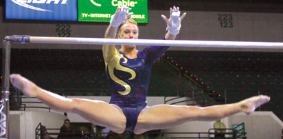 Senior co-captain Christina Lenny performs on the uneven bars at the meet on Friday. She earned a first-place score of 9.875 for this event. Photo by Lindsay Frumker.