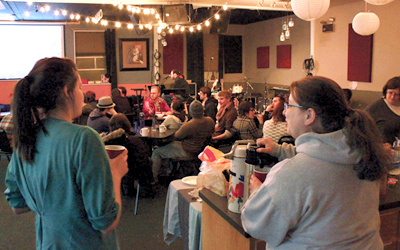 Vineyard Community Church members enjoy a slideshow during the church’s last potluck get-together. The song “On a Sunday” plays as they reflect on the fun times they’ve shared. Photo by MICHELLE BAIR.