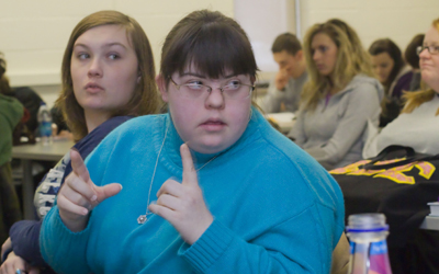 Megan Rothermel signs her mother a question during a class. Megan is a student in the Campus Transition Project, an educational program for people with intellectual disorders. Photo by Coty Giannelli.