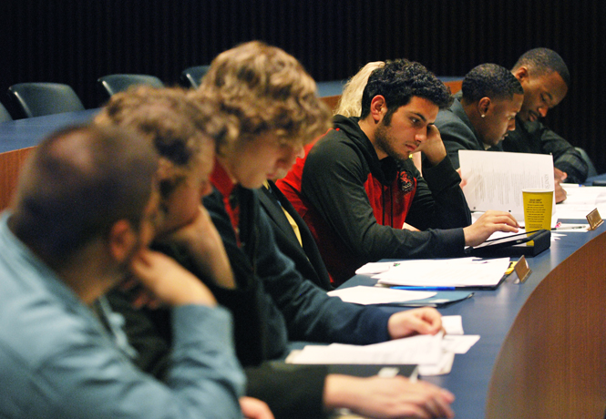 Omar Nemer, senior Honors College senator, works on his iPad during Wednesday night’s USG meeting. The senators and directors talked about lobbying at the Columbus State House March 16th for issues pertaining to Kent State.. Photo by Phil Botta.