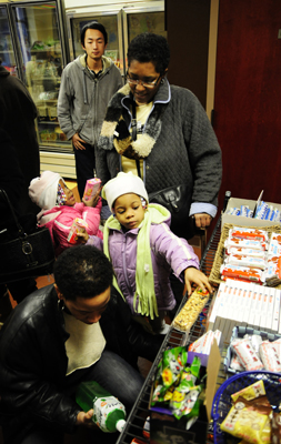 Michelle Mattox, Lianna Whitmore and Essence and Naeje Whitmore peruse the variety of international products offered at International HOME Markets on Saturday. International HOME Markets is the newest addition to Acorn Alley. Co-owner Crystal King, an entrepreneurship and international business double major, said turnout had been great on their opening day. "We created the store to get international students more active in the community," King said. "You can always bring people together through food and eating." Photo by Hannah Potes.