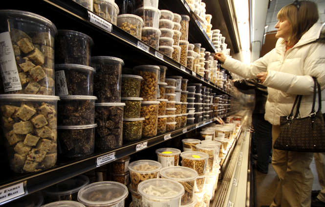 A customer at The Mustard Seed Market, located in Fairlawn, looks at the fresh nuts and produce for sale. The Mustard Seed Market prides itself on the organic products and healthy foods it offers to customers. Photo by Nikolas Kolenich.