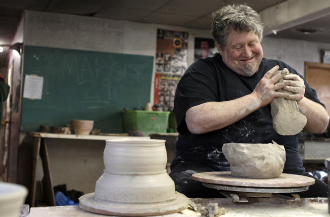 Associate professor Kirk Mangus demonstrates how to make various dining pieces in the ceramics lab on Monday. Mangus is the head of the ceramics department at Kent State. Photo by Nikolas Kolenich