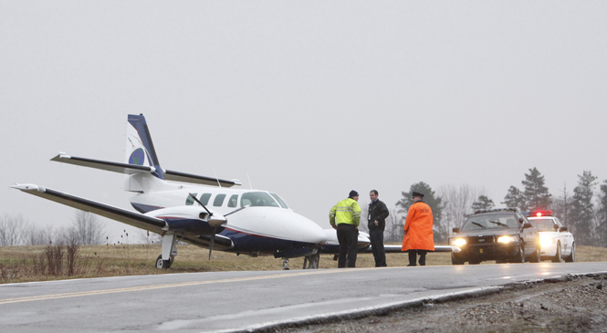 A commercial aircraft sits in a ditch on North River Road in Stow Tuesday. David Poluga, KSU airport's operation coordinator, said the accident resulted in no injuries. A pilot and five passengers were inside the aircraft. Photos by Nikolas Kolenich