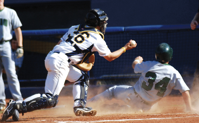 Sophomore catcher David Lyon shows the umpire the ball after tagging a runner out to end the eighth inning during the Flashes' 5-4 win against Ohio University Friday. Photo by Tessa Bargainnier.