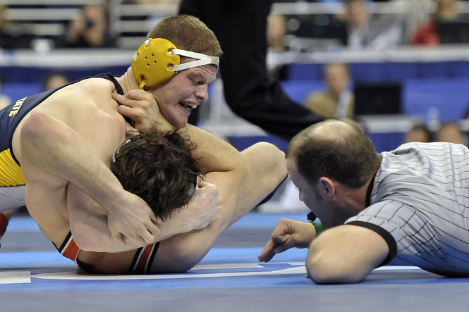 Dustin Kilgore of Kent State University wrestles Clayton Foster of Oklahoma State University during the Division I Men's Wrestling Championship held at the Wells Fargo Center in Philadelphia, PA. Kilgore defeated Foster by fall to win the 197 pound national title. Photo courtesy of Drew Hallowell/ Associated Press.