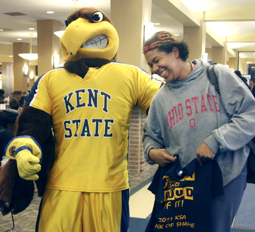 Rachel Weese, sophmore HDF youth studies major, is cited for wearing a non-KSU college sweatshirt on campus Tuesday. Flash hunted down students and handed out T-shirts to several offenders to boost campus pride. Photo by Valerie Brown.