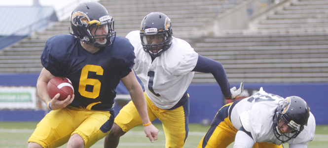 Senior wide receiver Chris Gilbert avoids a tackle during spring football practice last Tuesday. Photo by Jessica Yanesh.