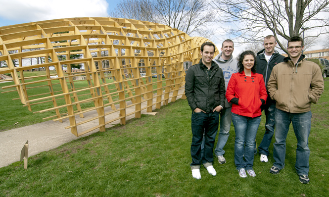 Brian Thoma, Carl Veith, Victoria Capranica, Matt Veith and Griffin Morris, all architecture graduate students, stand next to “The Passage” which they all worked to create. The structure is located outside Taylor Hall and will be removed before May 4th. Photo by Matt Hafley.