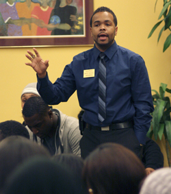 Bruce Mitchell, assistant director of Upward Bound Classic, addresses the crowd at the emergency Black United Students meeting held in the Multicultural Center Tuesday. Mitchell asked, "What legacy will you leave behind?" Photo by Valerie Brown.