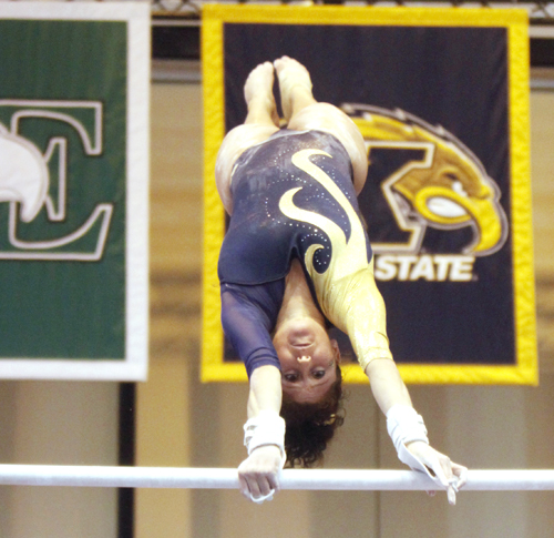 Senior Christine Abou-Mitri perfroms on the uneven bars Saturday at the M. A. C. Center. Abou-Mitri socred a 9.750 on the uneven bars during the Flashes' 195.100-194.875 loss to Central Michigan. Photo by Jessica Yanesh.