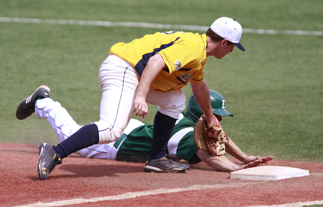 Kent sophomore first baseman George Roberts attempts to tag out Eastern Michigan freshman first baseman Lee Longo at Schoonover Field on Sunday. Photo by Lindsay Frumker.