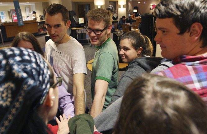 (From left) Barry Habusta, sophomore psychology major, Lorenzo Thomas, Activities Coordinator and sophomore philosophy major, Jamie Mileti, president and sophomore psychology major and other members of the soon to be student organization Gay Rights Revolutionaries met in the cyber cafe in the basement of the student center on Tuesday. The group--which will be an official group next school year--discusses current LGBT news, plans event to spread awareness, then ends each meeting with a group bonding exercise. Photo by Valerie Brown.