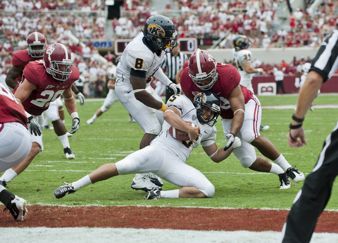 Alabama offensive players tackled Kent State's defensive lineman Roosevelt Nix at the away game on Saturday September 3, 2011. The Flashes fell to the Crimson Tide 48-7. Photo by Drew Hoover.