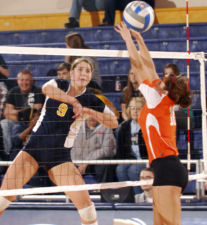 Senior outside hitter Lauren Jones hits the ball between the hands of Bowling Green's defense. Photo by Philip Botta.