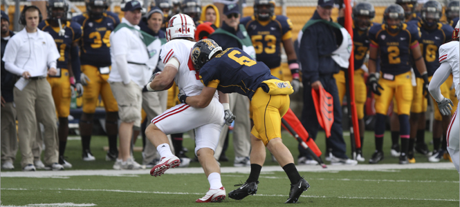 Wide receiver Chris Gilbert tackles Miami linebacker Colin Boucher during Kent State’s homecoming game.