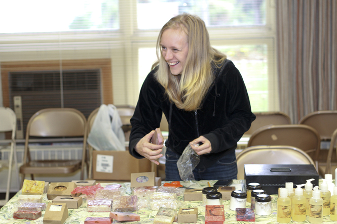 Danielle Waskowksi, of Stow, sells homemade soaps at the Stow Community Farmer's Market on Saturday, Oct. 15. Waskowski, a self-proclaimed "locavore," takes pride in supporting local businesses and buys most of her food at farmers markets. Photo by Anthony Vence.