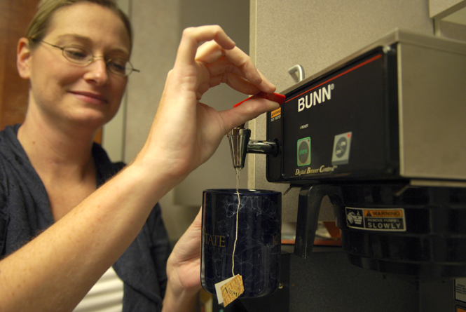 Director of Public Relations and Marketing Communications Jennifer Kramer made a cup of tea in a break room in Moulton Hall Tuesday, Oct. 25. A new policy requires faculty and staff to buy their own coffee and tea. Photo by Monica Maschak.