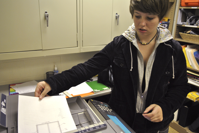 Freshman visual communication design major Chloe Hackathorn turns in copies of her notes for two lecture classes one to two times a week. Students are paid by the semester and the notes are passed on to students in special need of them for certain classes through the Student Accessibility Center. Photo by Jenna Watson.