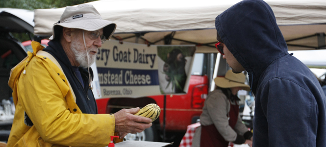 Richard DiRienzo from Carrollton, helped a customer, Maz Weinstein, 28, from Kent, at the Haymaker Farmers' Market in Kent on Saturday, Oct. 1. Photo by Elyse Claassen.