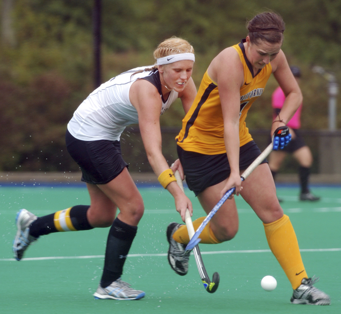 Senior midfielder Carla Johl stick tackles a California player. Photo by Matt Hafley.