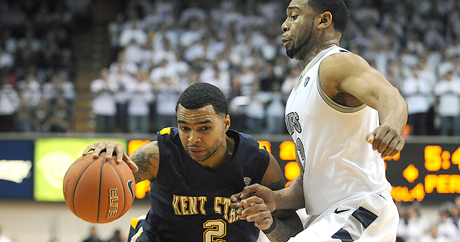 Kent State senior guard Michael Porrini attempts to pass the ball past Akron defenders on Saturday, Jan. 21 at the University of Akron's James A. Rhodes Arena. The Akron Zips beat the Golden Flashes 84-75. Photo by Kristen Bauer.