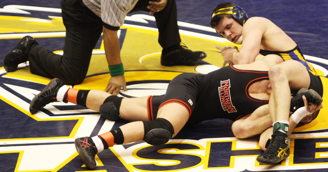 Brandonn Johnson attempts to pin Caleb Busson in the Flashes wrestling match against Northern Illinois University on Jan. 21, 2011. Johnson, sophomore exploratory major, won against Greenhaw 4-1. File photo by Valerie Brown.