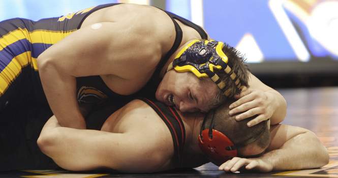 Brendan Barlow pins Dakota Greenhaw in Friday's match against Northern Illinois University. Barlow, junior exploratory major, won against Greenhaw 4-1. Photo by Valerie Brown.