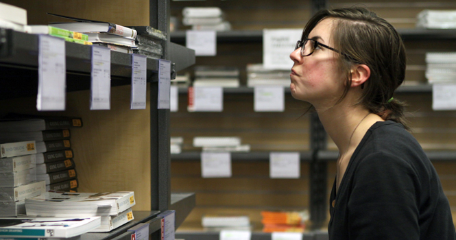 Adrienne Langan, 21-year-old fashion merchandising major, searches for a book at the campus book store in the Student Center on Tuesday. Students, with receipts, can return books for a full refund up until Jan. 17. Photo by Coty Giannelli.