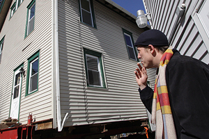 South Willow Street resident and Junior English major Ashton Kamburoff has a front row seat to the house moving on Feb. 20. The house, which used to house former Kent faculty member May H. Prentice was moved to help make way for the new University Esplanade, which will connect campus to downtown. Photo by Brian Smith.