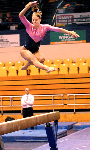 Sophomore Marie Case jumped on the balance beam during Kent State's meet against Western Michigan during last year's Flip for the Cure on Feb. 27. The Gymnastics team will go against Northern Illinois on Sunday, Feb. 19 at 1 p.m. in this year's Flip for the Cure meet. Photo by Jackie Friedman.