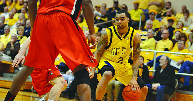 Michael Porrini, senior guard, dribbles around Jarrod Jones, senior foward, at the game against Ball State on Feb. 11. The Flashes won 76-55. Photo by Nancy Urchak.