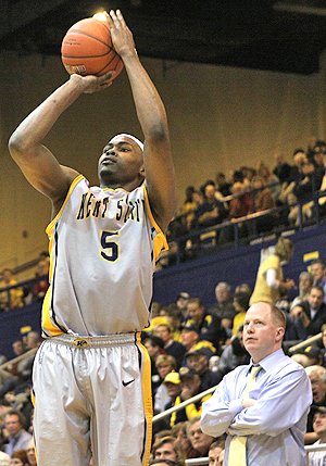 Junoior forward Chris Evans shoots from the 3-point line during the Flashes game against the College of Charleston. Evans, along with Guyton, lead the team with 16 points each in the Flashes 80-73 lose. Photo by Coty Giannelli.