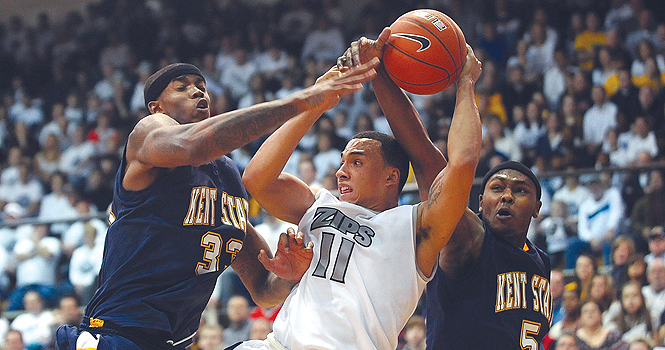 Kent State senior center Justin Manns and junior forward Chris Evans try to block Akron from scoring on Saturday, Jan. 21 at the University of Akron’s James A. Rhodes Arena. The Akron Zips beat the Flashes 84-75. File Photo.