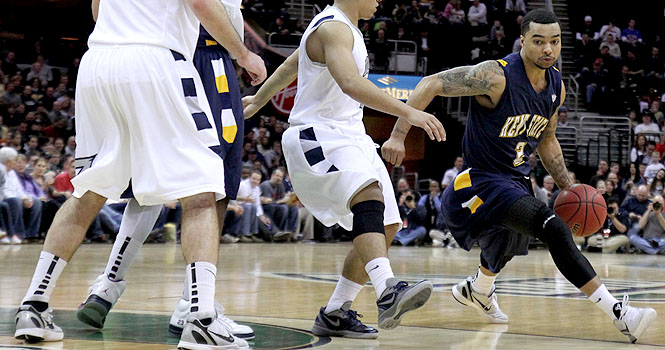 Senior guard Michael Porrini dribbles past sophomore guard Alex Abreu, senior forwards Justin Greene and Nikola Cvetinovic at the Q on March 9. The Flashes fell to the Zips 74 to 78. Photo by Adrianne Bastas.