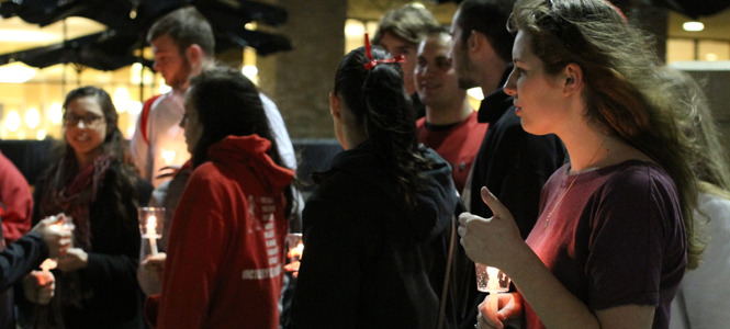 Freshman Amanda Hill, a former Chardon High School student, keeps her commemorative candle lit awaiting a Chardon group photo at the vigil for victims of the Chardon High School shooting, Feb. 29. Photos by Chelsae Ketchum.