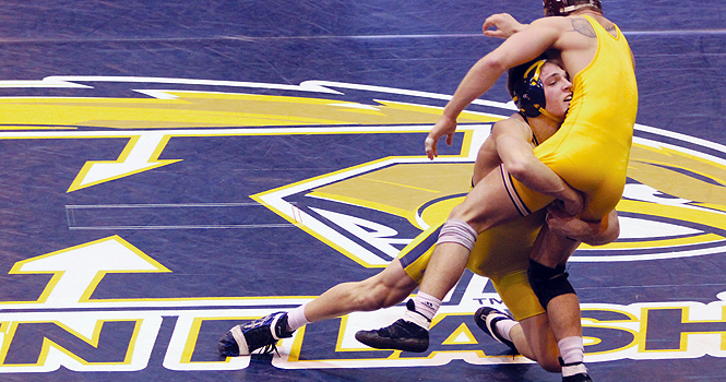 Freshman Ian Miller wrestles down Central Michigan's Joey Kielbasa during the Jan. 29 meet at the M.A.C. Center. Miller won the match by major decision. Kent State beat Central Michigan 22-13. Photo by Anthony Vence.