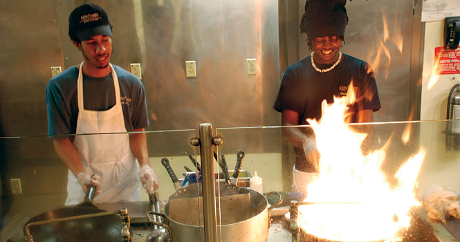 Junior communications studies major Alex McNulty and junior physical therapy major John Kamau work at Asian Express on Feb. 3. Photo by Grace Jelinek.