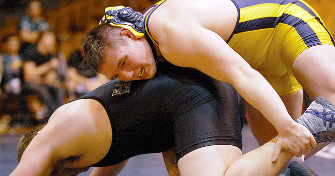 Senior 285 class Brendan Barlow wrestles Nick Whitenburg, sophomore, at the match against Eastern Michigan on Feb. 5. The Flashes won 28-10. File photo.