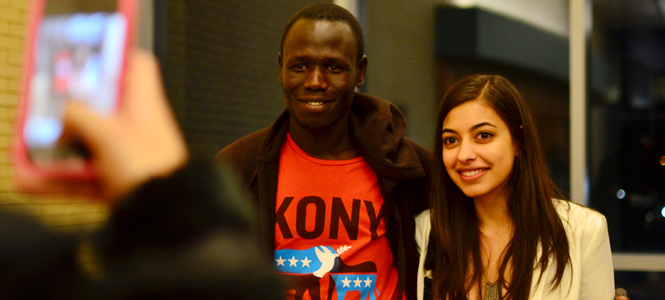 Reshmi Mehta, sophomore political science major and member of Kent State's Invisible Children chapter posed for a picture with Richard Olunya, an engineer working to build schools in the northern region of Uganda. Photo by Jacob Byk.