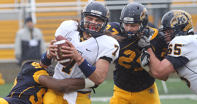 Senior quarterback David Fisher gets sacked during the Spring Football Game. The Gold Team defeat the Blue Team on Saturday’s game, 21-0. Photo by Rachel Kilroy.