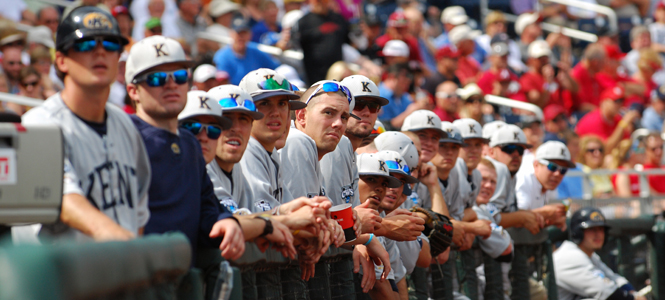 Members of the Kent State University baseball team watch an instant replay of a contested call during the College World Series June 16 in Omaha, Neb. The Flashes lost their first game against Arkansas. Photo by Philip Botta.