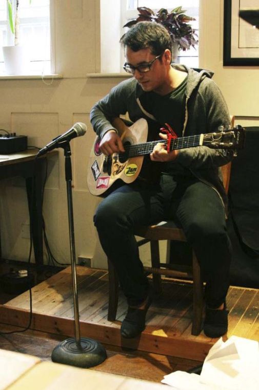 Jack Gazdik performs at open mic night while classmates support his British debut. A crowd favorite was “Remix to Ignition” by R. Kelly. Gazdik said he firmly stands by his belief that it is the best song ever. Photo courtesy of Natalie Moses.