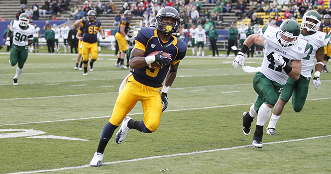 Junior wide receiver Tyshon Goode attempts to run the ball into the end zone during the Flashes’ last regular season game at Dix Stadium on Nov. 19. Goode’s 4th quarter touchdown put the Flashes ahead 28-22 and allowed them to defeat Eastern Michigan. Photo by Jessica Yanesh.