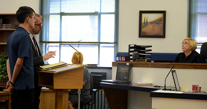 William Koberna and his attorney Paul Cristallo are addressed by Judge Barbara Oswick during a hearing Friday morning in the Kent Municipal Court. Koberna is no longer facing felony charges of inducing panic after making threats on Twitter to "shoot up" Kent State University.. Photo by Matt Hafley.