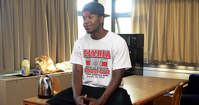 Demetrius Walton, freshman occupational therapy, sits in his room, a lounge, in Dunbar on Aug. 26. "It's bigger than the dorm room," Walton said. "I love it. I'd rather live here." Photo by Nancy Urchak.