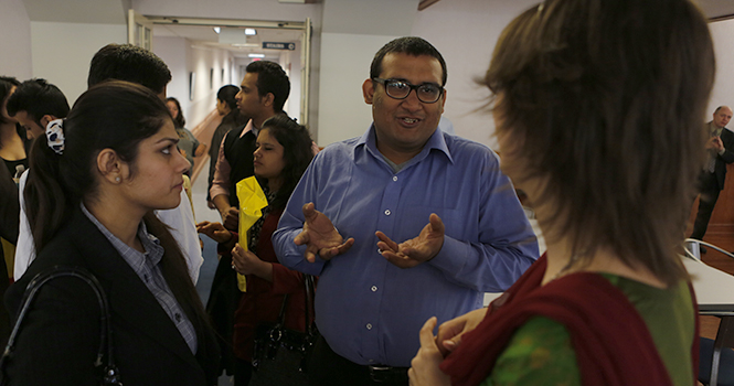 Smrithi Kuchhal, Harshit Walia, from Amity University in Noida, India, and Melinda Yoho, a photo illustration student, talk after the welcoming of students from Amity University. Kent State students who studied abroad in Spring 2012 will be helping the Indian students report on local stories. Photo by Coty Giannelli.