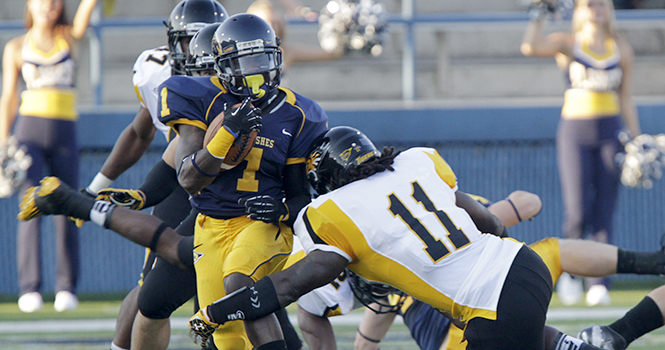 Senior runningback Dri Archer attempts to break a tackle from Towson during Kent's first game on August 30. The Flashes will play at Buffalo at 7 p.m. on Wednesday. Photo by Phillip Botta.