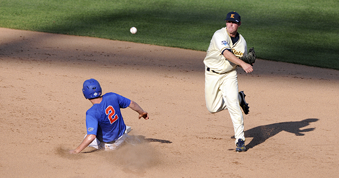 Jimmy Rider throws the ball to first baseman Cody Koch to complete a double play against Florida during the Flashes first victory at the College World Series in Omaha, Neb. The Flashes beat the Gators 5-4 Monday, June 18. Photo by Philip Botta.