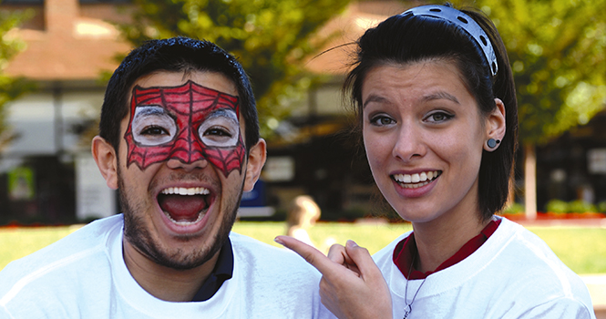 Sophomore Michael Weisel poses with senior Victoria Humphreys after getting his face painted at the LNC/SALSA Festival on September 14. Weisel and Humphreys are members of the Native American Student Association, which recently reformed at Kent State.. Photo by MARIELLE FORREST.